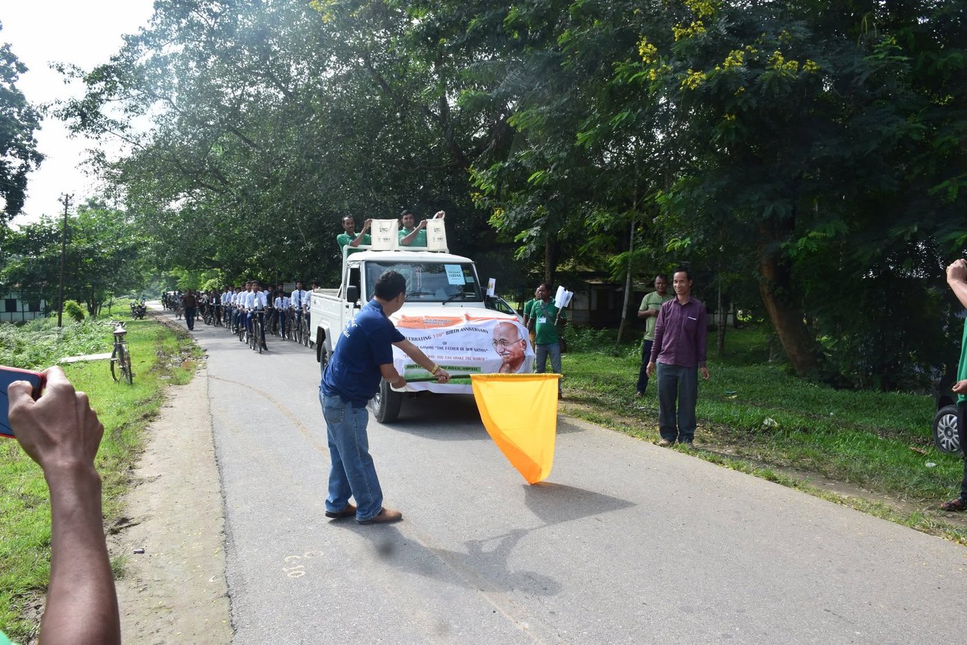A cycle rally being flagged off with campaign cloth bags