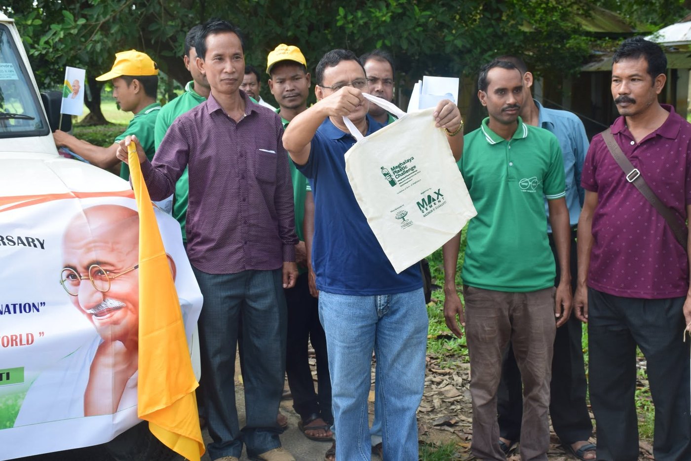 A campaign cloth bag held up at a rally flag off